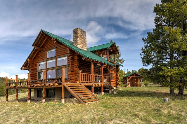 30 Douglas Lee Ln, Anaconda, MT 59711 - rear view of property featuring log siding, a chimney, a deck, and a metal roof