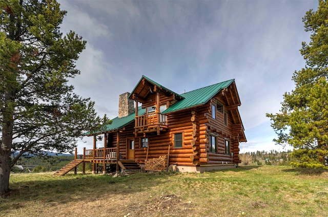 30 Douglas Lee Ln, Anaconda, MT 59711 - view of side of property with log siding, a balcony, a chimney, a metal roof, and stairs