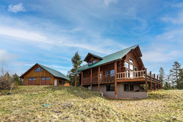 30 Douglas Lee Ln, Anaconda, MT 59711 - view of home's exterior featuring an outbuilding, a metal roof, a garage, a deck, and log siding