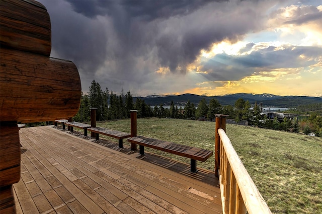 30 Douglas Lee Ln, Anaconda, MT 59711 - deck at dusk featuring a mountain view and a lawn