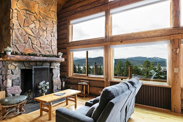 30 Douglas Lee Ln, Anaconda, MT 59711 - living area with rustic walls, a mountain view, hardwood / wood-style floors, a fireplace, and a towering ceiling