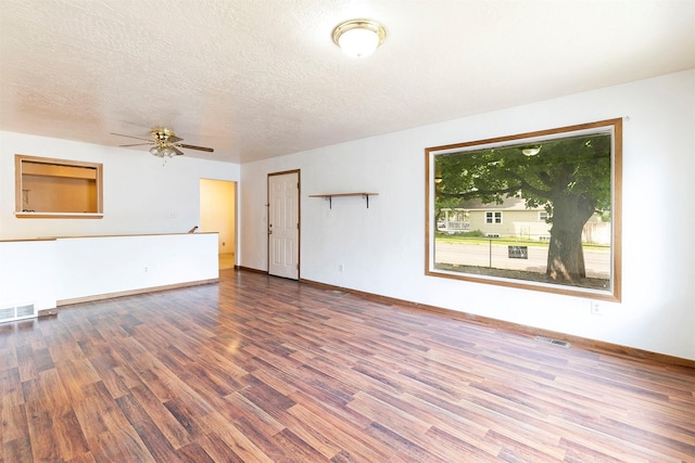 470 Strand Ave, Missoula, MT 59801 - unfurnished living room featuring wood finished floors, a ceiling fan, and a textured ceiling
