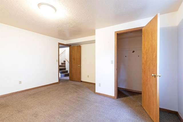 470 Strand Ave, Missoula, MT 59801 - unfurnished bedroom with carpet, a textured ceiling, and a closet