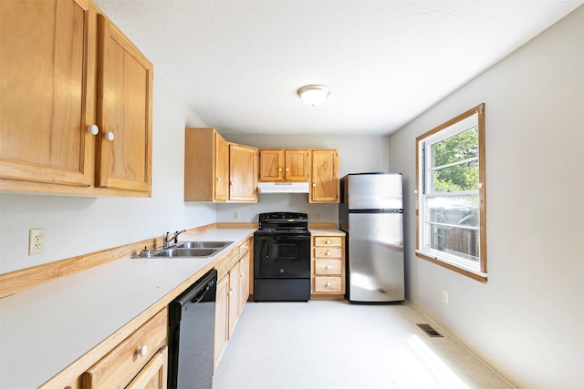470 Strand Ave, Missoula, MT 59801 - kitchen featuring black appliances, under cabinet range hood, light countertops, and light brown cabinets