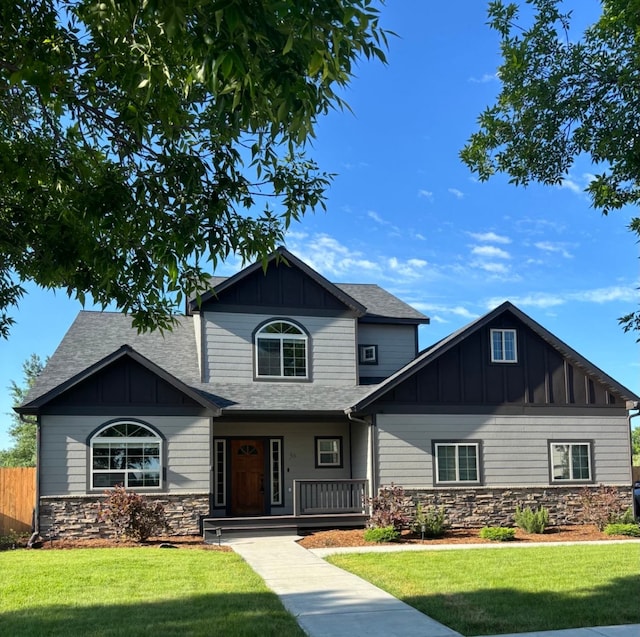 36 Silo St, Belgrade, MT 59714 - craftsman-style home with stone siding, board and batten siding, a shingled roof, and covered porch
