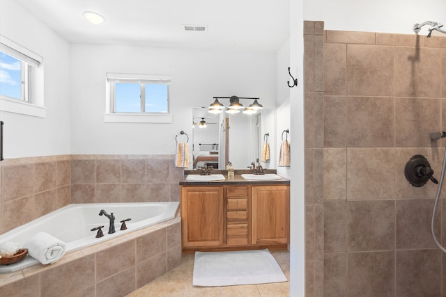 36 Silo St, Belgrade, MT 59714 - bathroom featuring double vanity, a garden tub, tiled shower, tile patterned flooring, and a ceiling fan