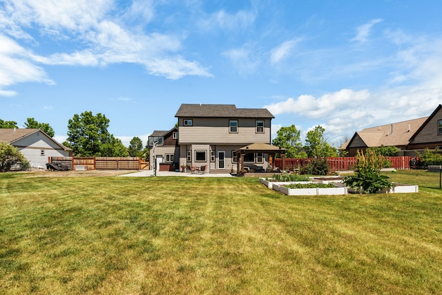 36 Silo St, Belgrade, MT 59714 - back of house with a patio, a vegetable garden, and a fenced backyard