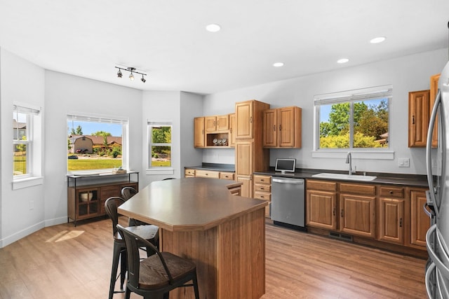 36 Silo St, Belgrade, MT 59714 - kitchen featuring stainless steel appliances, dark countertops, a breakfast bar area, light wood-style floors, and recessed lighting