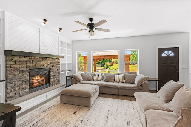 36 Silo St, Belgrade, MT 59714 - living area featuring a fireplace, a ceiling fan, and built in shelves