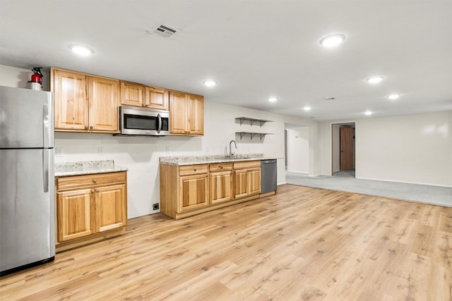 1940 Dixon Ave, Missoula, MT 59801 - kitchen with appliances with stainless steel finishes, light wood-style floors, recessed lighting, light stone counters, and open floor plan