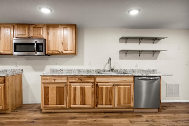 1940 Dixon Ave, Missoula, MT 59801 - kitchen featuring stainless steel appliances, light stone countertops, and wood finished floors