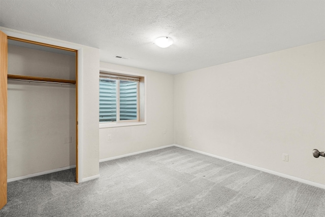 1940 Dixon Ave, Missoula, MT 59801 - unfurnished bedroom with carpet, a closet, and a textured ceiling