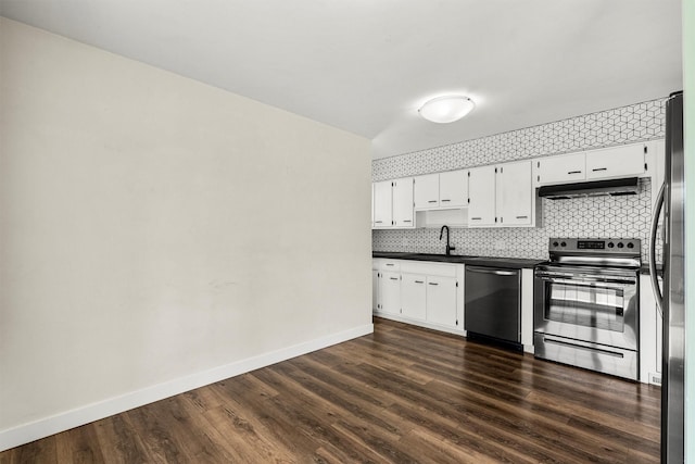 1940 Dixon Ave, Missoula, MT 59801 - kitchen with appliances with stainless steel finishes, under cabinet range hood, dark countertops, and dark wood-style floors