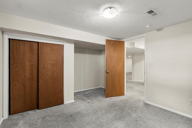 1940 Dixon Ave, Missoula, MT 59801 - unfurnished bedroom with carpet flooring, a closet, and a textured ceiling