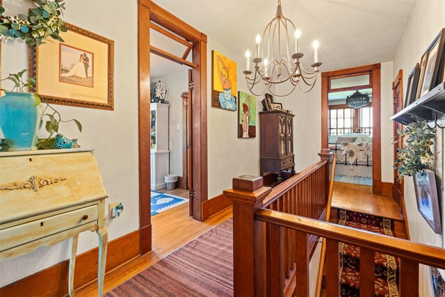 101 Lewis Ln, Hamilton, MT 59840 - corridor featuring wood finished floors, a chandelier, and an upstairs landing
