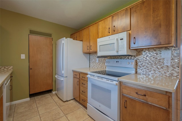 5706 Shannon Ct, Helena, MT 59602 - kitchen featuring white appliances, tasteful backsplash, light countertops, and light tile patterned floors