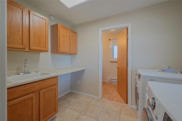 5706 Shannon Ct, Helena, MT 59602 - laundry area with a baseboard heating unit, cabinet space, washer and dryer, and light tile patterned floors