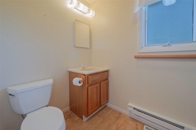 5706 Shannon Ct, Helena, MT 59602 - bathroom featuring baseboard heating, vanity, and wood finished floors