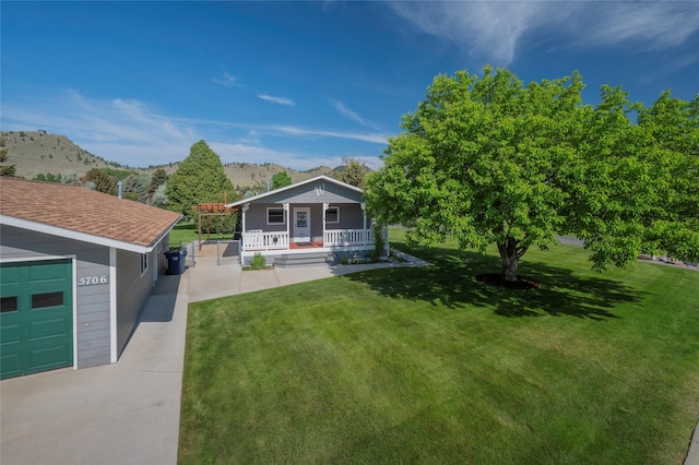 5706 Shannon Ct, Helena, MT 59602 - view of green lawn with covered porch and a mountain view