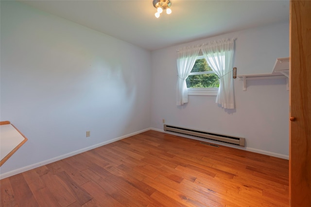5706 Shannon Ct, Helena, MT 59602 - unfurnished bedroom with a baseboard heating unit and wood finished floors