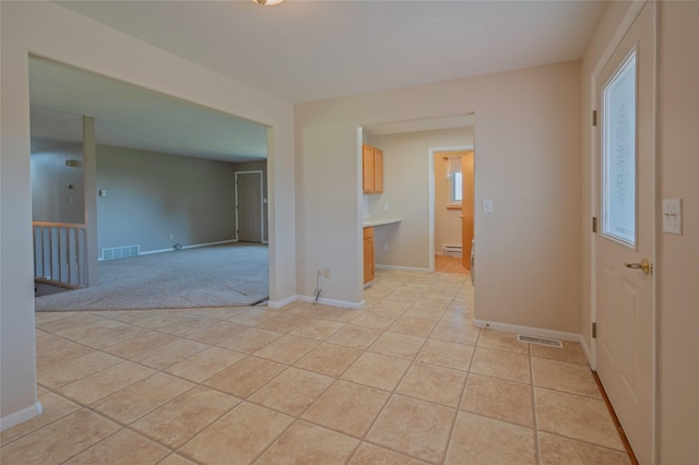 5706 Shannon Ct, Helena, MT 59602 - spare room with light tile patterned flooring, light colored carpet, and baseboard heating