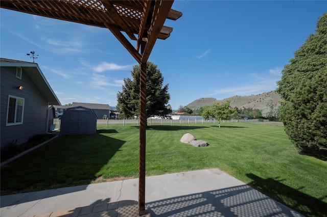 5706 Shannon Ct, Helena, MT 59602 - view of yard with a mountain view, a storage unit, a patio, and a pergola