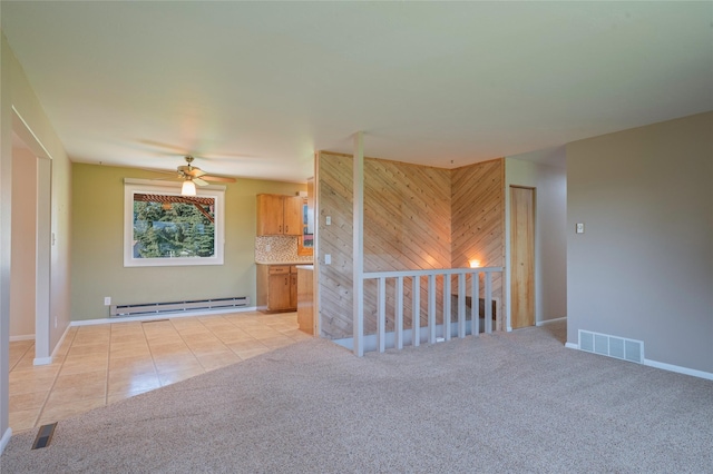 5706 Shannon Ct, Helena, MT 59602 - spare room with baseboard heating, ceiling fan, light tile patterned floors, and light colored carpet