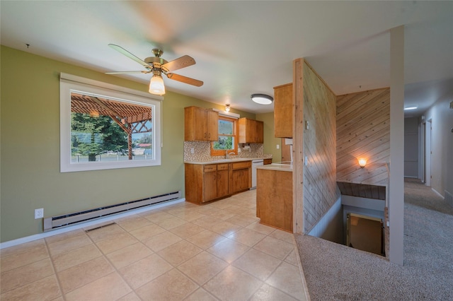 5706 Shannon Ct, Helena, MT 59602 - kitchen with baseboard heating, brown cabinetry, tasteful backsplash, dishwasher, and light countertops
