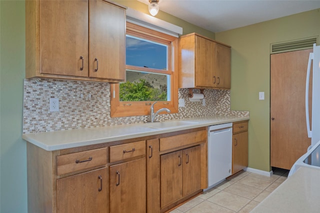 5706 Shannon Ct, Helena, MT 59602 - kitchen with dishwasher, light countertops, light tile patterned floors, and backsplash