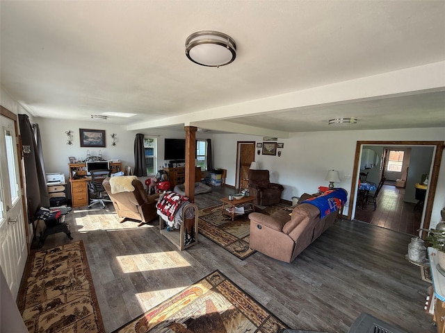 306 E Missoula Ave, Troy, MT 59935 - living room featuring wood finished floors, ornate columns, plenty of natural light, and a desk