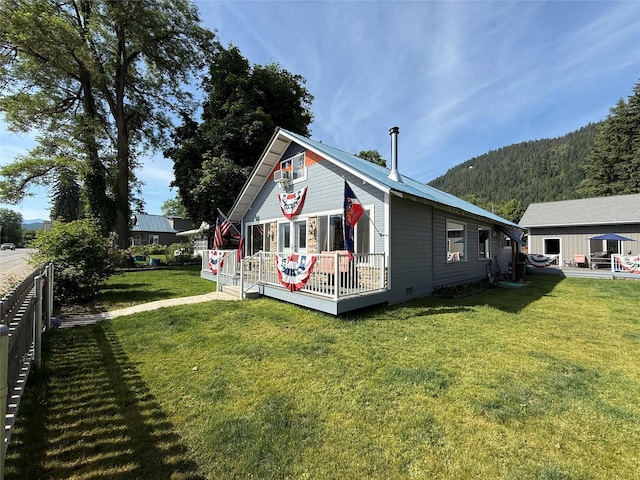 306 E Missoula Ave, Troy, MT 59935 - view of side of property featuring a deck with mountain view and crawl space