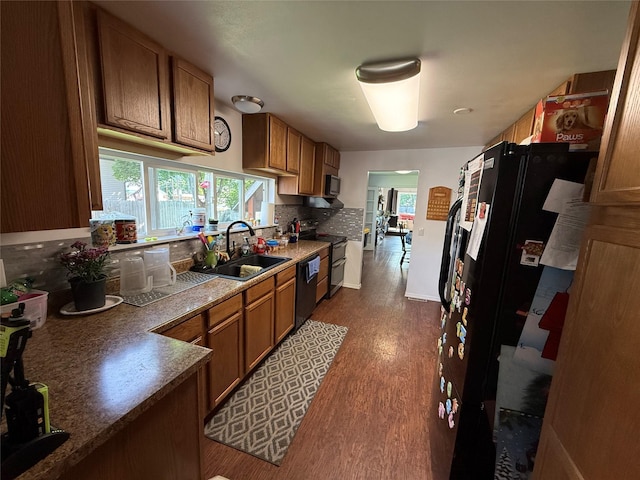 306 E Missoula Ave, Troy, MT 59935 - kitchen with electric stove, brown cabinets, dark wood-type flooring, and backsplash