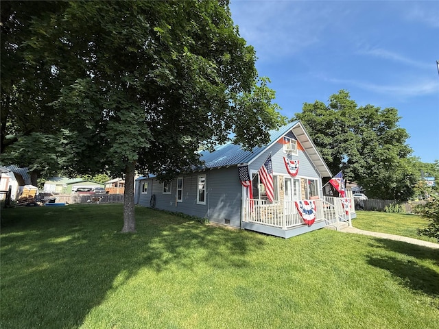 306 E Missoula Ave, Troy, MT 59935 - view of side of property with crawl space and a metal roof