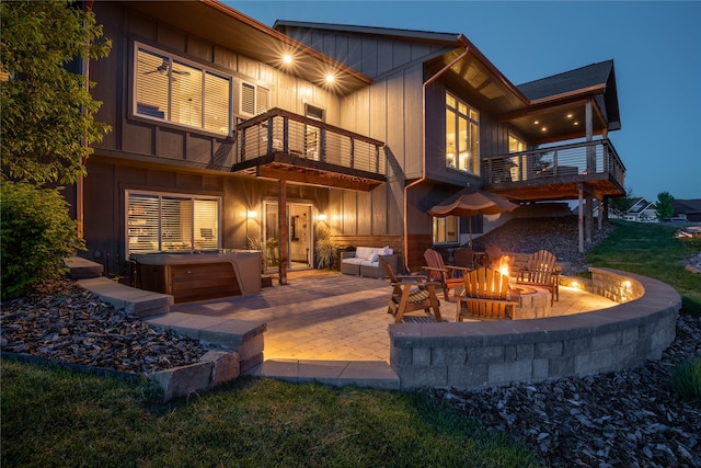 3069 Trading Post Pl, Missoula, MT 59808 - rear view of property with a balcony, a hot tub, a fire pit, and a patio area