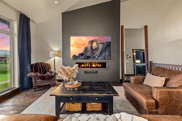 3069 Trading Post Pl, Missoula, MT 59808 - living area with vaulted ceiling, a warm lit fireplace, and wood finished floors