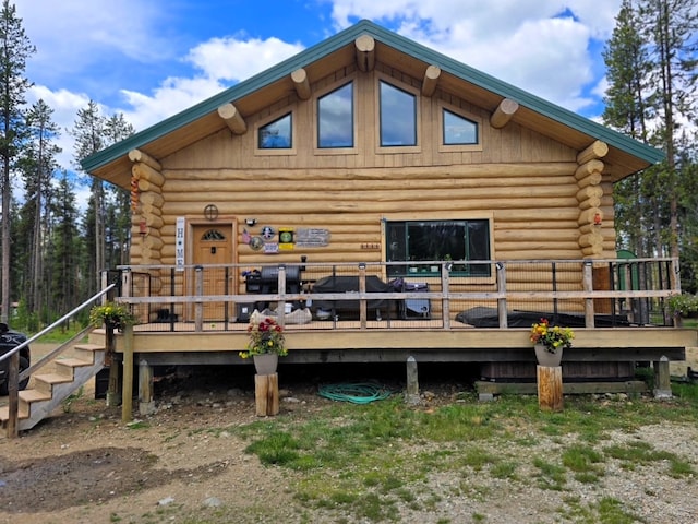 223 E G St, Sula, MT 59871 - rear view of house featuring log siding and a deck