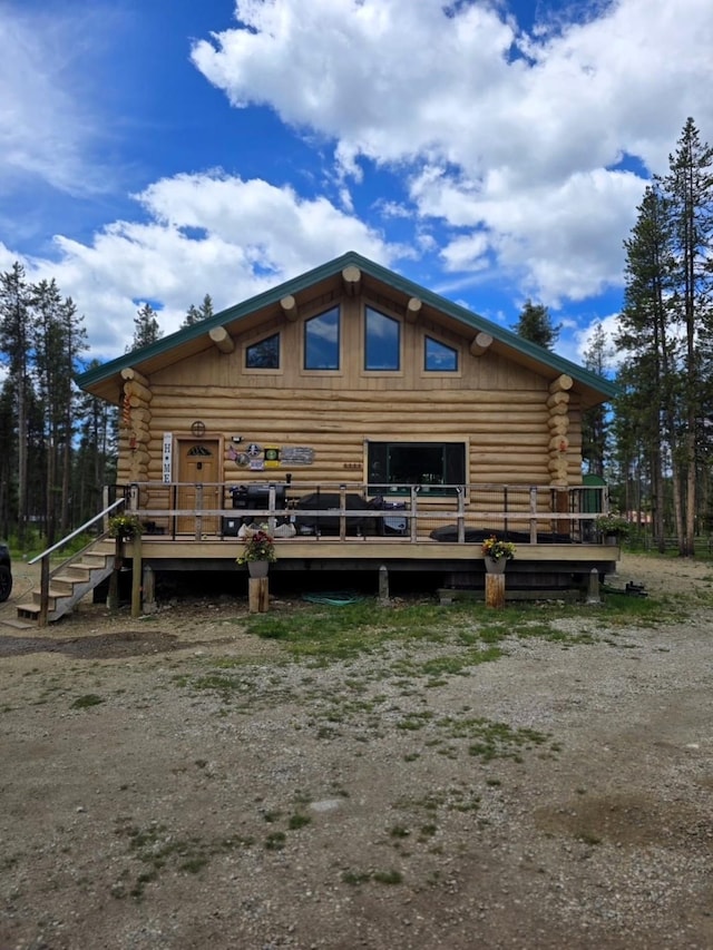 223 E G St, Sula, MT 59871 - rear view of property with log siding and a deck