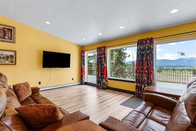2813 Pine Lakes Ct, Stevensville, MT 59870 - living area with baseboard heating, light wood finished floors, recessed lighting, and lofted ceiling