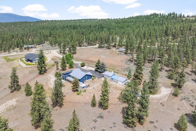 2813 Pine Lakes Ct, Stevensville, MT 59870 - view of subject property featuring a heavily wooded area and a mountainous background
