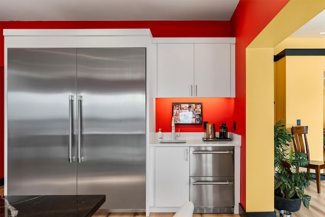 2813 Pine Lakes Ct, Stevensville, MT 59870 - kitchen featuring built in fridge, white cabinetry, light countertops, and dishwasher