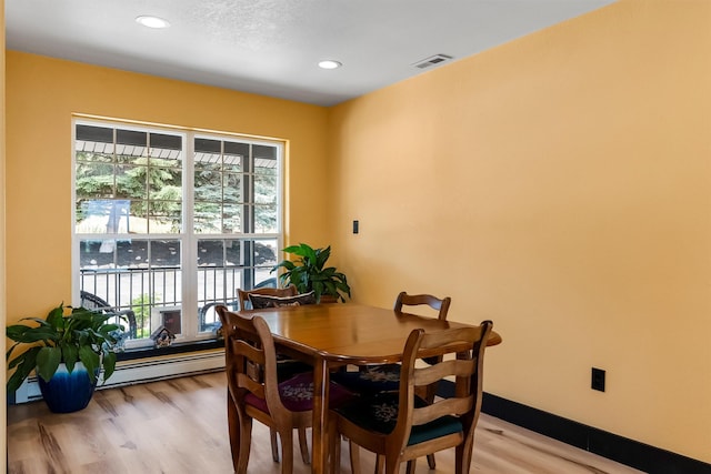 2813 Pine Lakes Ct, Stevensville, MT 59870 - dining space featuring baseboard heating, light wood-type flooring, and recessed lighting