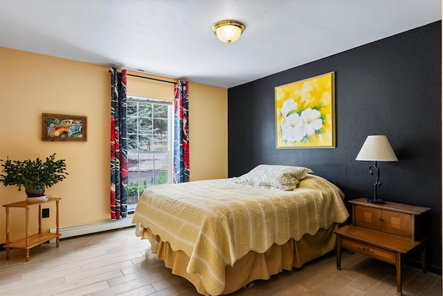 2813 Pine Lakes Ct, Stevensville, MT 59870 - bedroom with wood finished floors, baseboard heating, and an accent wall