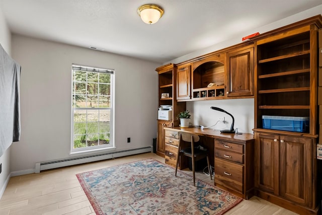 2813 Pine Lakes Ct, Stevensville, MT 59870 - home office featuring baseboard heating, light wood-type flooring, and built in desk