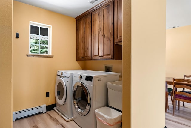 2813 Pine Lakes Ct, Stevensville, MT 59870 - laundry area with a baseboard radiator, cabinet space, light wood-style flooring, and washer and dryer