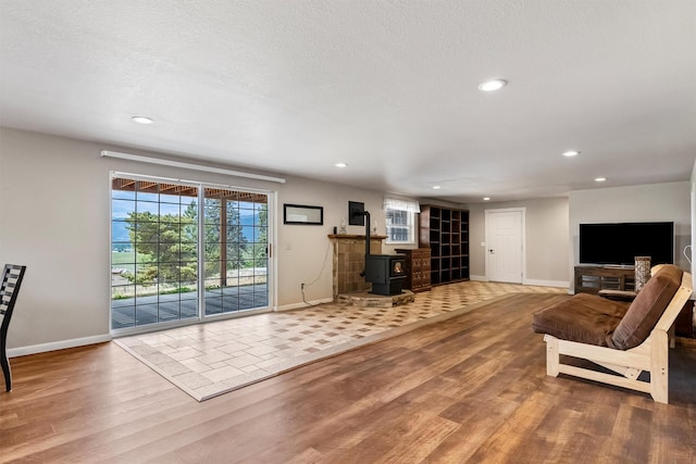 2813 Pine Lakes Ct, Stevensville, MT 59870 - living room with a wood stove, wood finished floors, and recessed lighting