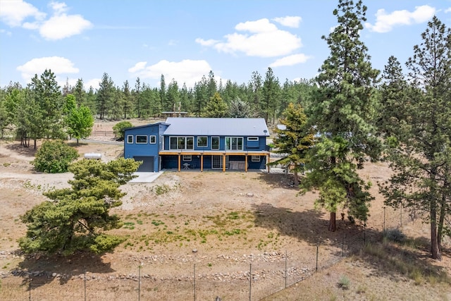 2813 Pine Lakes Ct, Stevensville, MT 59870 - rear view of house with an attached garage and a deck