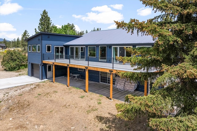 2813 Pine Lakes Ct, Stevensville, MT 59870 - rear view of house with a garage, driveway, and a patio area