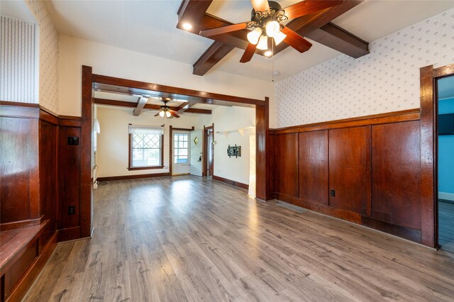 1805 2nd Ave N, Great Falls, MT 59401 - unfurnished living room with ceiling fan, a wainscoted wall, beamed ceiling, wallpapered walls, and wood finished floors