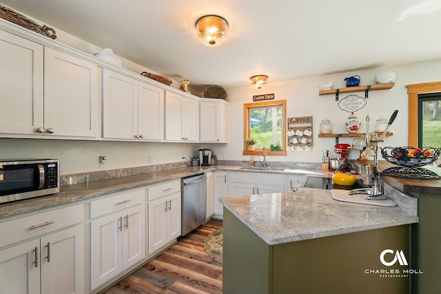 2623 Gold Rush Ave, Helena, MT 59601 - kitchen with appliances with stainless steel finishes, wood finished floors, white cabinetry, open shelves, and light stone counters