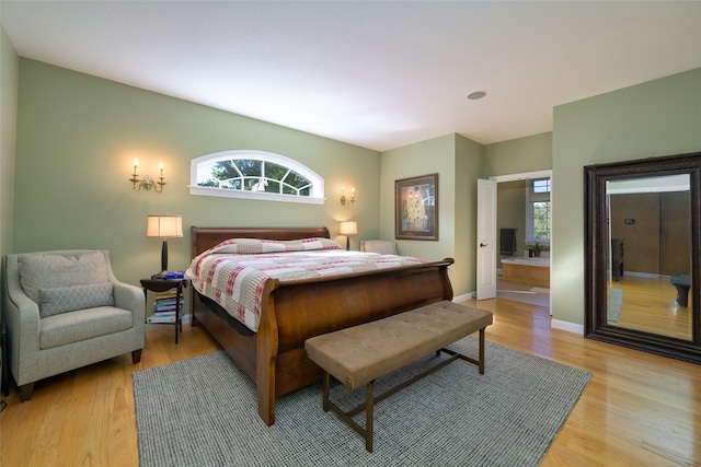 8785 Jacot Ln, Missoula, MT 59808 - bedroom with light wood finished floors and ensuite bathroom